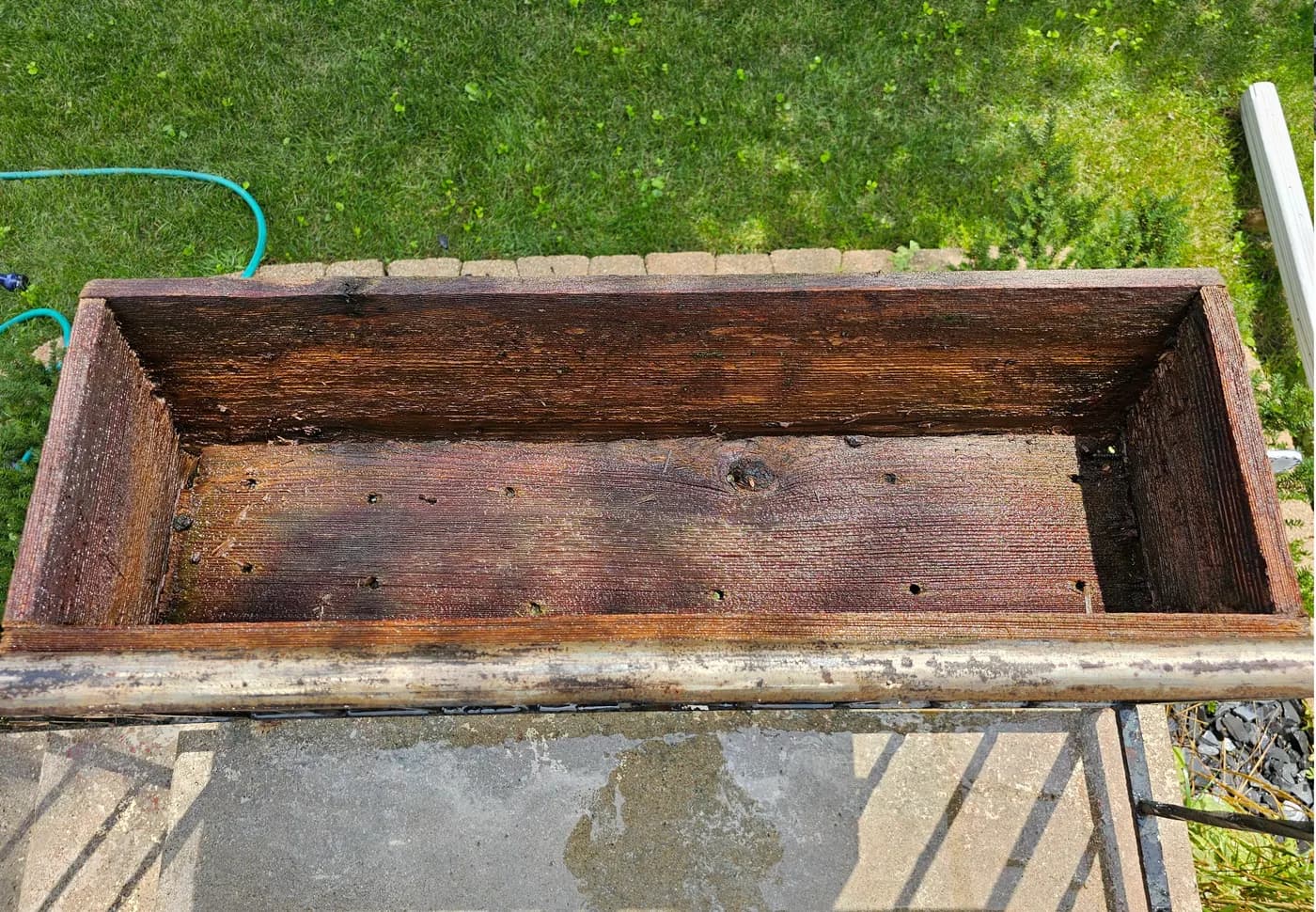 The same planter box cleaned down to rich brown bare wood.