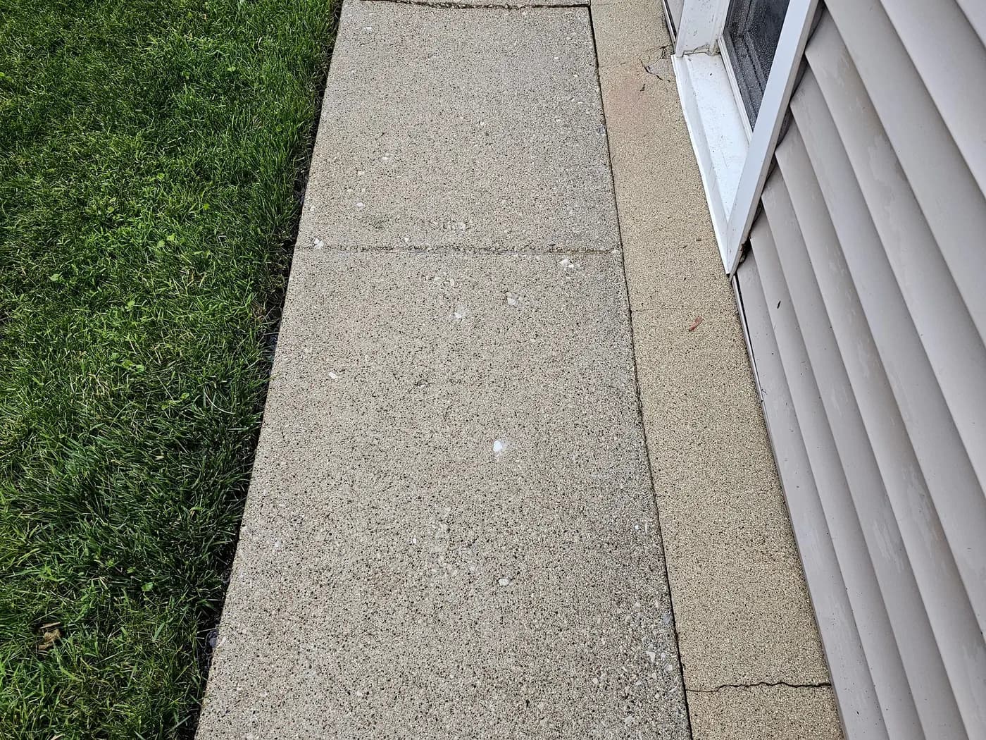 The same walkway washed clean, the concrete returned to a light natural gray.